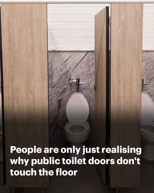 Why do public bathroom doors not reach the floor?